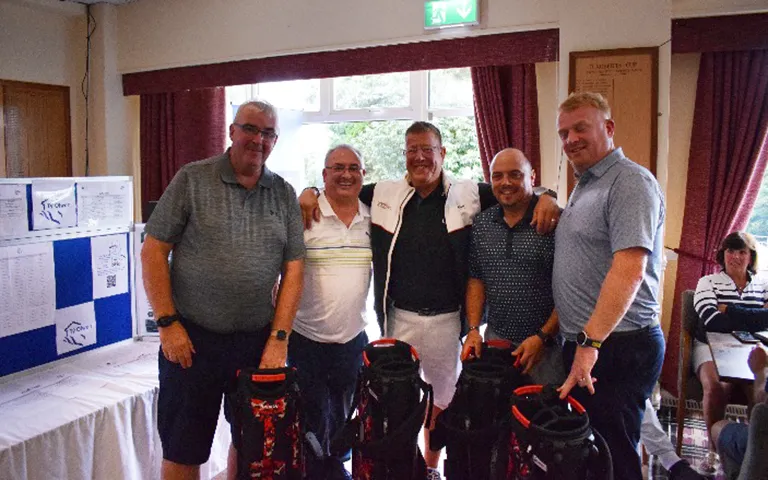 The winning golf team posing with C&P CEO Paul Bunyan